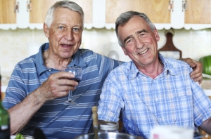 Couple of smiling male seniors at meal time